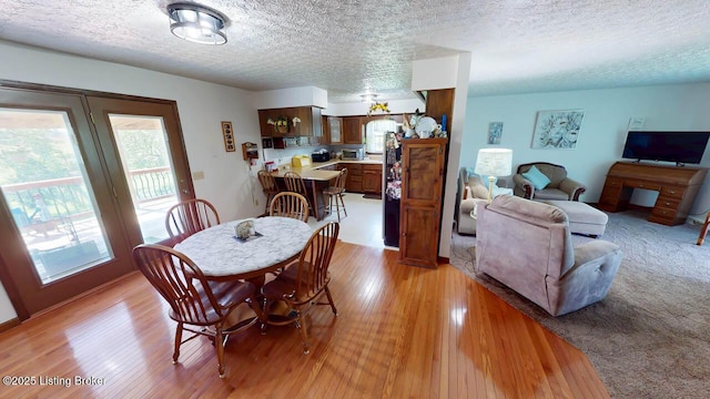2149 Shrewsbury Rd, Leitchfield, KY 42754 - dining room featuring light wood-type flooring and a textured ceiling