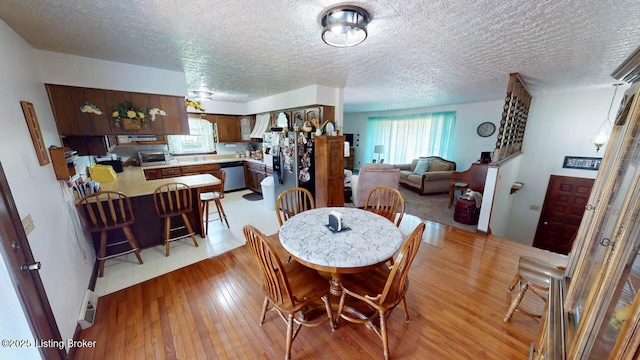 2149 Shrewsbury Rd, Leitchfield, KY 42754 - dining room with light wood-type flooring and a textured ceiling