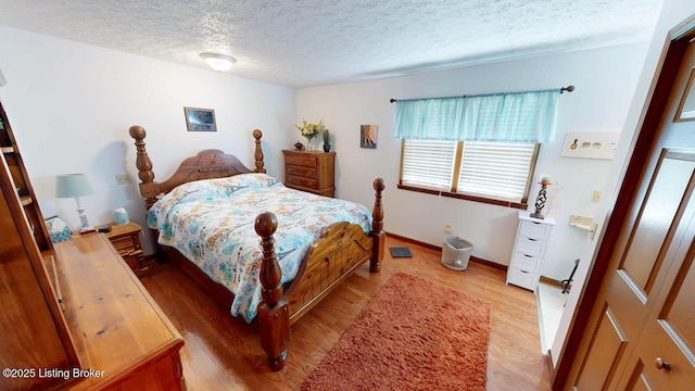 2149 Shrewsbury Rd, Leitchfield, KY 42754 - bedroom with light wood finished floors and a textured ceiling
