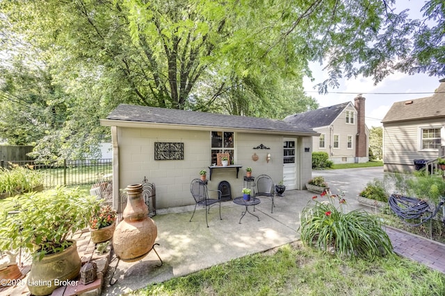 3119 Bobolink Rd, Louisville, KY 40213 - rear view of house featuring a patio, roof with shingles, and concrete block siding