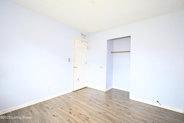 119 E Blue Jay Rd, Louisville, KY 40229 - unfurnished bedroom with wood finished floors and a closet