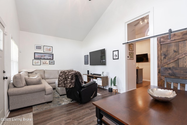 835 Forrest St, Louisville, KY 40217 - living area featuring a barn door, high vaulted ceiling, and dark wood finished floors