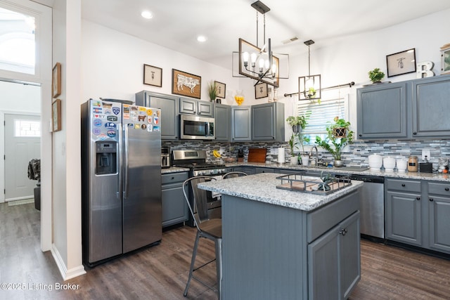 835 Forrest St, Louisville, KY 40217 - kitchen featuring stainless steel appliances, gray cabinets, backsplash, dark wood-style floors, and recessed lighting