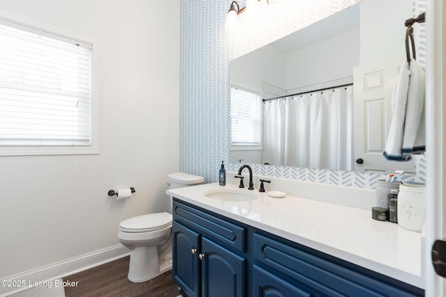 835 Forrest St, Louisville, KY 40217 - full bath featuring vanity, wood finished floors, and a shower with shower curtain