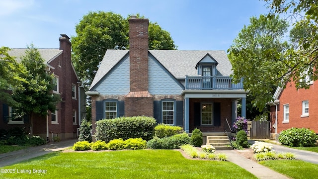 3615 Hycliffe Ave, Louisville, KY 40207 - english style home with a balcony, a front lawn, brick siding, roof with shingles, and a porch