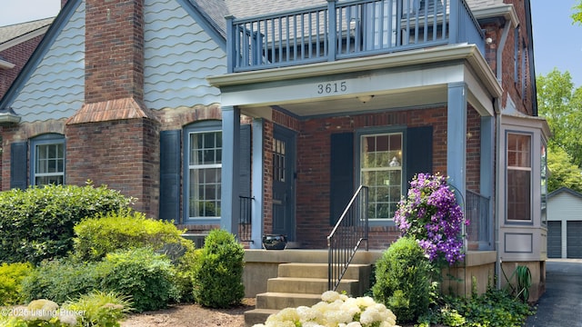 3615 Hycliffe Ave, Louisville, KY 40207 - property entrance featuring a balcony, a chimney, a garage, and brick siding