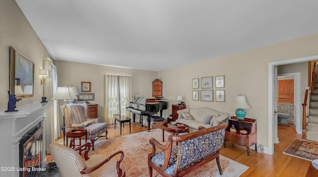3615 Hycliffe Ave, Louisville, KY 40207 - living area featuring a fireplace with flush hearth, light wood-style flooring, and stairway