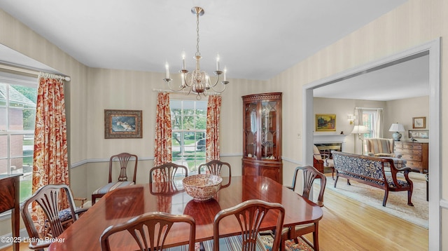 3615 Hycliffe Ave, Louisville, KY 40207 - dining area with wallpapered walls, a chandelier, light wood-style floors, and plenty of natural light