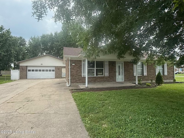 257 Big Oaks Dr, Louisville, KY 40229 - single story home featuring brick siding, concrete driveway, a front lawn, and covered porch