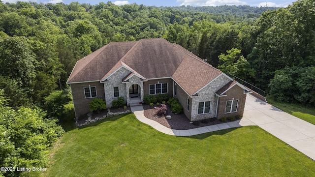 6103 Winkler Rd, Crestwood, KY 40014 - view of front of house featuring a wooded view, stone siding, a front yard, concrete driveway, and a shingled roof