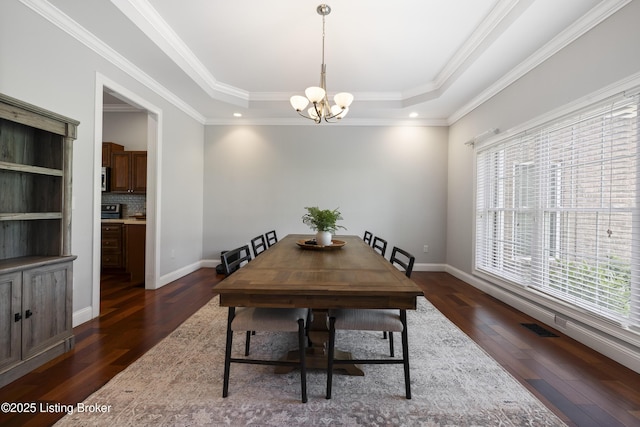 6103 Winkler Rd, Crestwood, KY 40014 - dining room featuring plenty of natural light, dark wood-type flooring, a chandelier, a raised ceiling, and ornamental molding