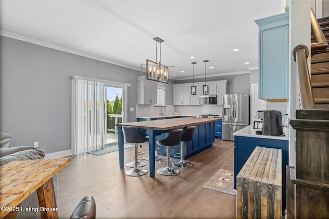 4066 Firestone Way, Shelbyville, KY 40065 - kitchen with stainless steel appliances, wooden counters, blue cabinets, light wood-style flooring, and a kitchen bar