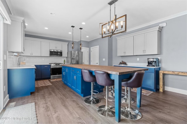 4066 Firestone Way, Shelbyville, KY 40065 - kitchen with stainless steel appliances, blue cabinetry, wood counters, dark wood-type flooring, and crown molding