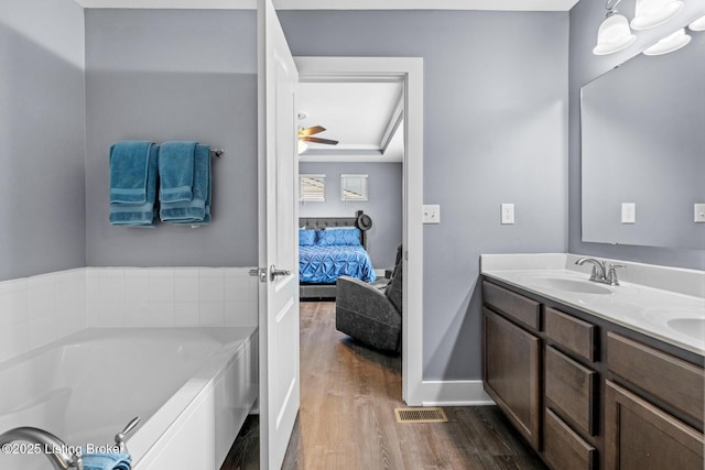 4066 Firestone Way, Shelbyville, KY 40065 - ensuite bathroom with wood finished floors, double vanity, a bath, and ceiling fan