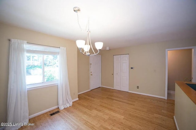 37 Lake Ave, Louisville, KY 40206 - unfurnished dining area featuring a chandelier and light wood-style flooring