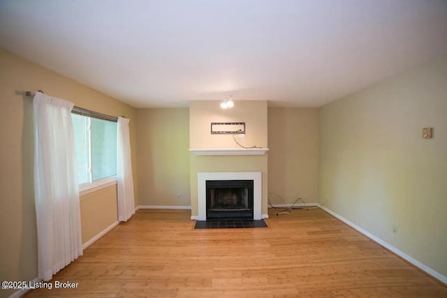 37 Lake Ave, Louisville, KY 40206 - unfurnished living room with wood finished floors and a fireplace with flush hearth