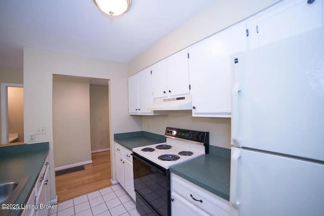 37 Lake Ave, Louisville, KY 40206 - kitchen featuring freestanding refrigerator, range with electric stovetop, under cabinet range hood, dark countertops, and white cabinetry