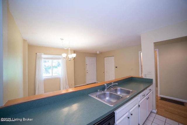 37 Lake Ave, Louisville, KY 40206 - kitchen featuring white cabinets, a chandelier, dark countertops, light tile patterned flooring, and decorative light fixtures