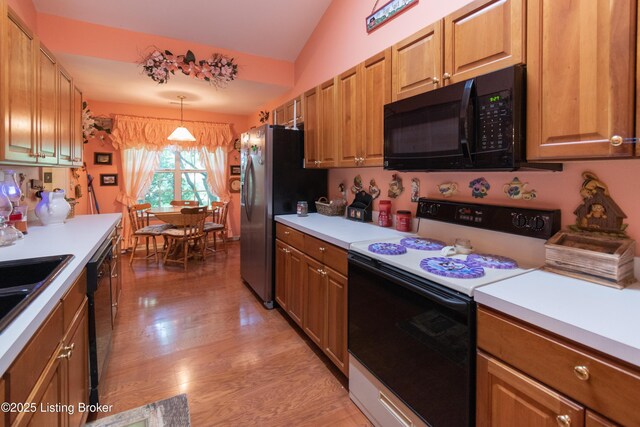 115 Canewood Blvd, Georgetown, KY 40324 - kitchen with electric range, black microwave, vaulted ceiling, light wood-type flooring, and light countertops
