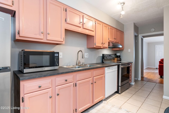 10757 Colonial Woods Ct, Louisville, KY 40023 - kitchen with appliances with stainless steel finishes, dark countertops, light tile patterned floors, and under cabinet range hood
