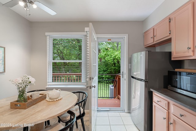 10757 Colonial Woods Ct, Louisville, KY 40023 - kitchen with stainless steel appliances, light tile patterned floors, a ceiling fan, and dark countertops