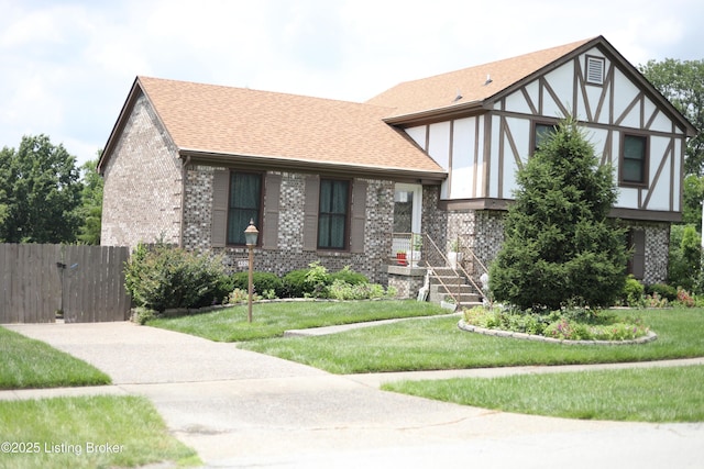 402 Bromwell Dr, Louisville, KY 40245 - english style home with brick siding, a shingled roof, and stucco siding