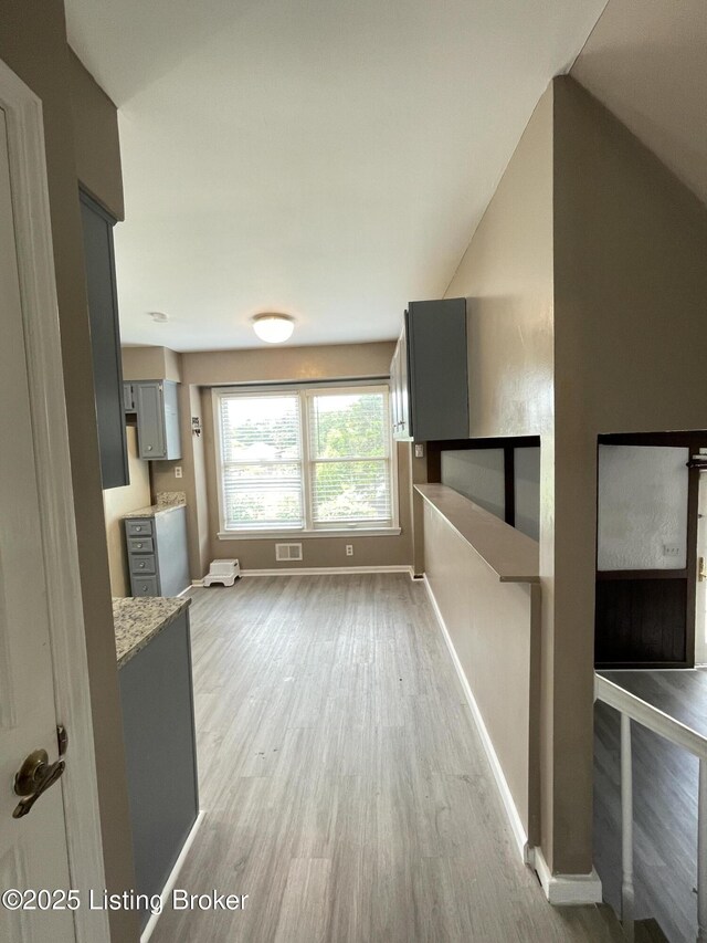 402 Bromwell Dr, Louisville, KY 40245 - unfurnished living room featuring light wood-style flooring and vaulted ceiling