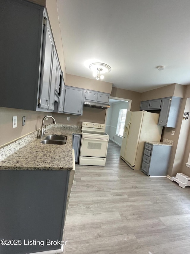 402 Bromwell Dr, Louisville, KY 40245 - kitchen with white appliances, under cabinet range hood, light wood finished floors, and gray cabinets