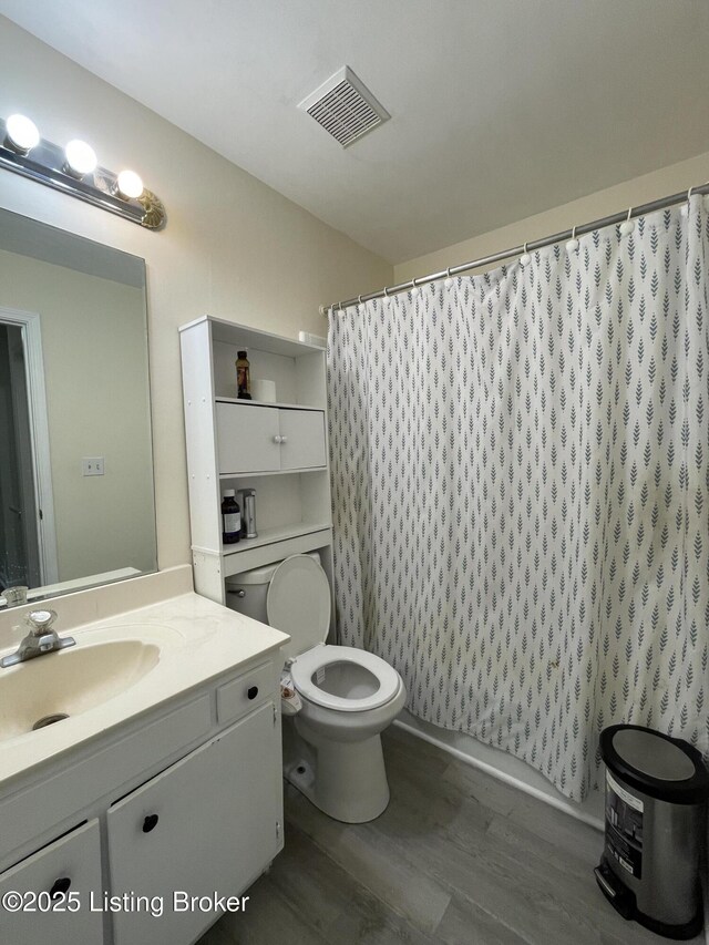 402 Bromwell Dr, Louisville, KY 40245 - full bathroom with wood finished floors, vanity, and a shower with curtain