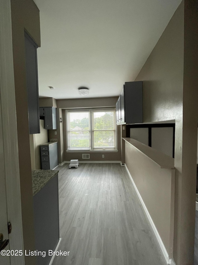 402 Bromwell Dr, Louisville, KY 40245 - unfurnished living room featuring wood finished floors and baseboards