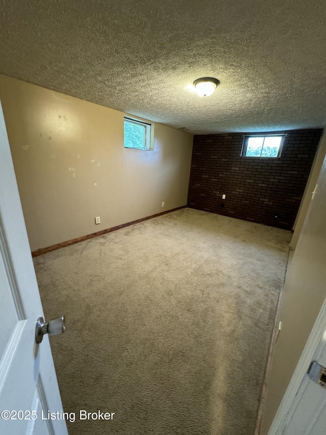 343 Navaho Rd, Brandenburg, KY 40108 - spare room with carpet floors, plenty of natural light, brick wall, and a textured ceiling