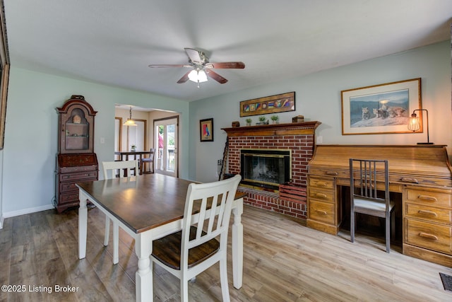 11208 Hasbrook Ct, Louisville, KY 40229 - dining space featuring a ceiling fan, wood finished floors, and a brick fireplace
