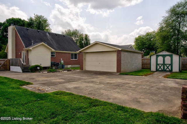 11208 Hasbrook Ct, Louisville, KY 40229 - view of front of house with an outdoor structure, a garage, and brick siding