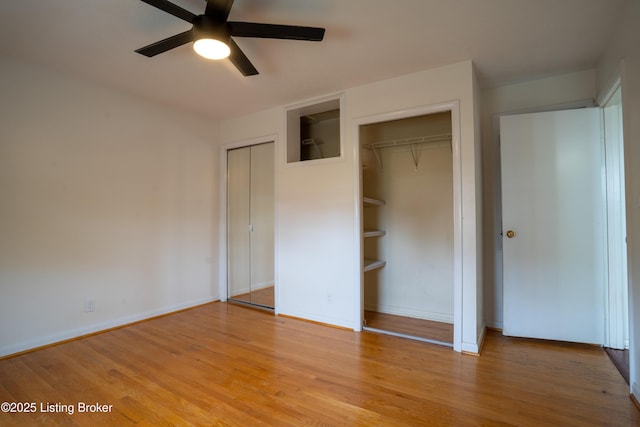 7906 Brynwood Ct, Louisville, KY 40291 - unfurnished bedroom with light wood-style floors, multiple closets, and a ceiling fan