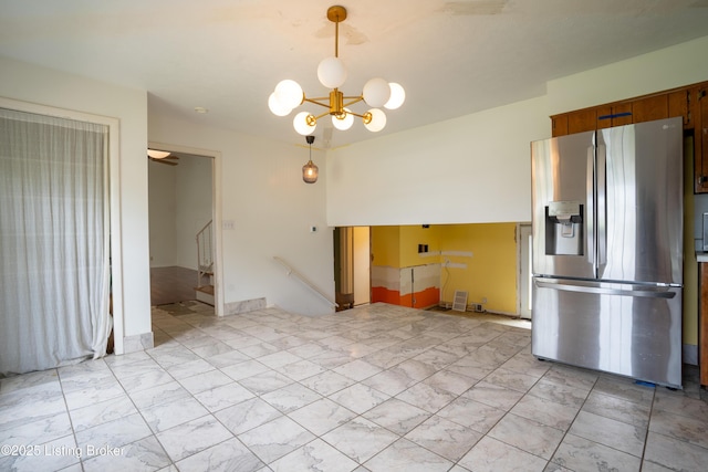 7906 Brynwood Ct, Louisville, KY 40291 - kitchen featuring stainless steel fridge, a chandelier, brown cabinets, and pendant lighting