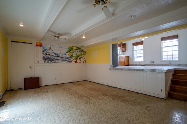7906 Brynwood Ct, Louisville, KY 40291 - interior space with a ceiling fan, beam ceiling, tile patterned floors, and a wainscoted wall
