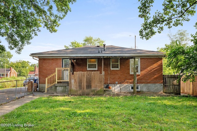 1833 Farnsley Rd, Louisville, KY 40216 - back of property with a fenced backyard, brick siding, and a gate