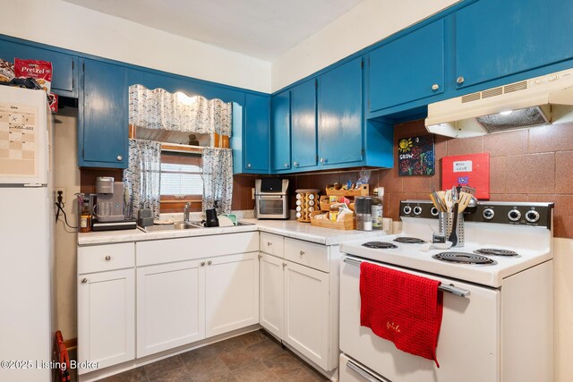 1833 Farnsley Rd, Louisville, KY 40216 - kitchen with white appliances, blue cabinetry, light countertops, under cabinet range hood, and tasteful backsplash