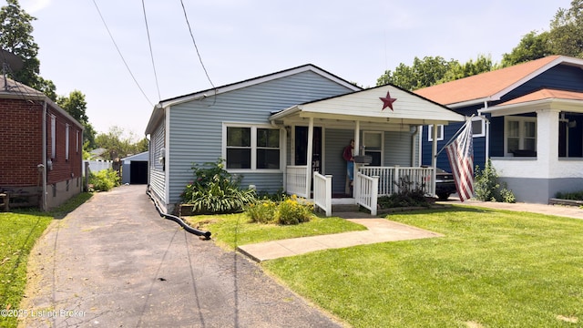 116 E Southern Heights Ave, Louisville, KY 40214 - bungalow-style house with covered porch, a front lawn, and a garage