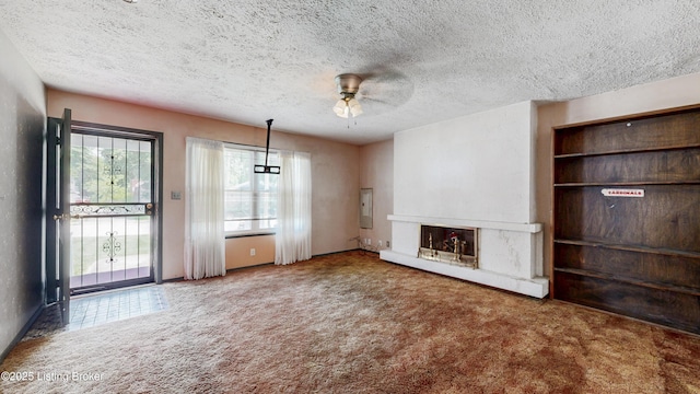 116 E Southern Heights Ave, Louisville, KY 40214 - unfurnished living room featuring carpet floors, ceiling fan, a fireplace with raised hearth, and a textured ceiling