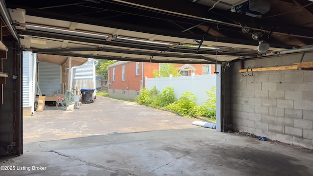 116 E Southern Heights Ave, Louisville, KY 40214 - garage featuring a garage door opener and concrete block wall