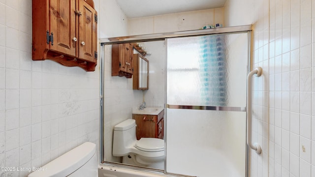116 E Southern Heights Ave, Louisville, KY 40214 - bathroom with tile walls, vanity, and a shower with shower door