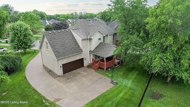 4301 Juniper Forest Pl, Louisville, KY 40245 - view of front facade featuring a shingled roof, a deck, a garage, a front yard, and driveway