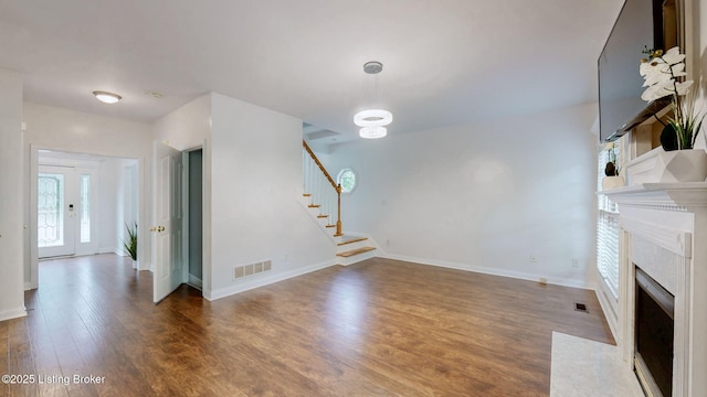 4301 Juniper Forest Pl, Louisville, KY 40245 - unfurnished living room featuring stairway, wood finished floors, and a high end fireplace