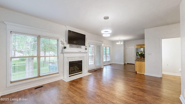 4301 Juniper Forest Pl, Louisville, KY 40245 - unfurnished living room with a chandelier, dark wood finished floors, and a high end fireplace