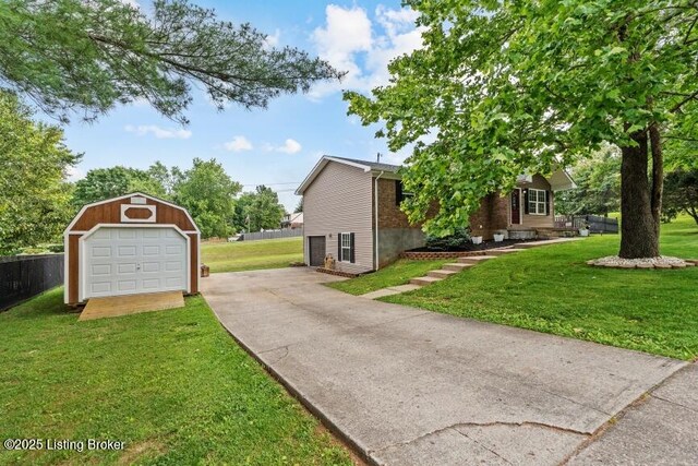 1376 Darlene Ct, Radcliff, KY 40160 - view of side of property featuring an outdoor structure, a garage, and concrete driveway
