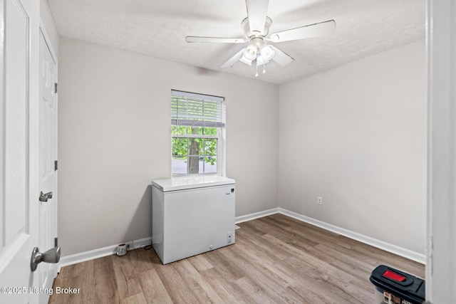 1376 Darlene Ct, Radcliff, KY 40160 - laundry room with light wood-style floors, ceiling fan, and a textured ceiling