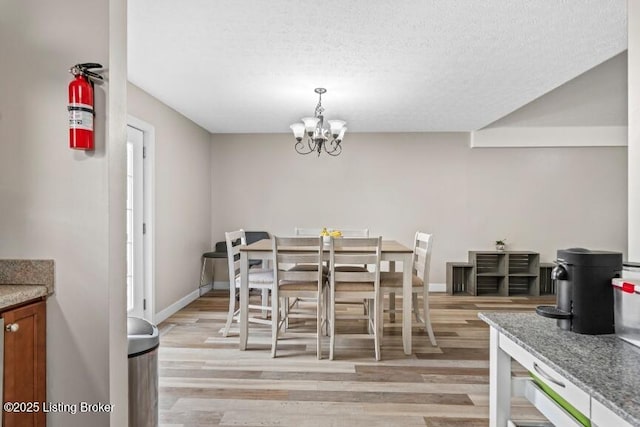 1376 Darlene Ct, Radcliff, KY 40160 - dining area with light wood-type flooring, a chandelier, and a textured ceiling