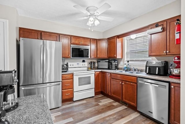 1376 Darlene Ct, Radcliff, KY 40160 - kitchen featuring stainless steel appliances, a ceiling fan, brown cabinetry, and light countertops