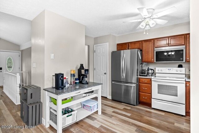 1376 Darlene Ct, Radcliff, KY 40160 - kitchen with white electric stove, freestanding refrigerator, brown cabinetry, ceiling fan, and light wood-style flooring